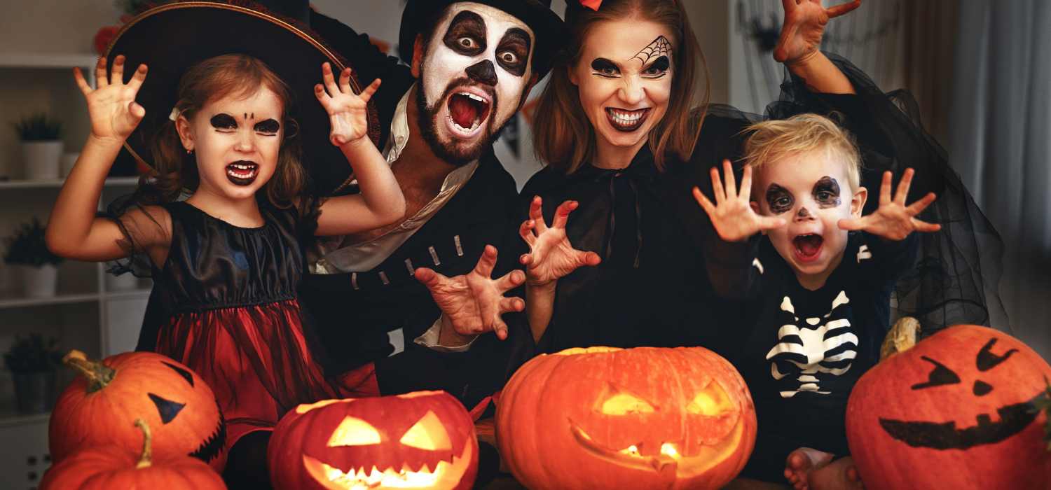 happy family mother father and children in costumes and makeup on Halloween